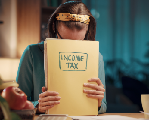 Worried woman checking documents about expat tax declaration and compliance.