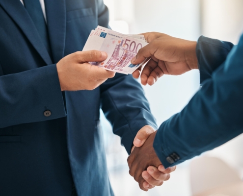 Businessmen exchanging money illustrating SARB tax compliance rules